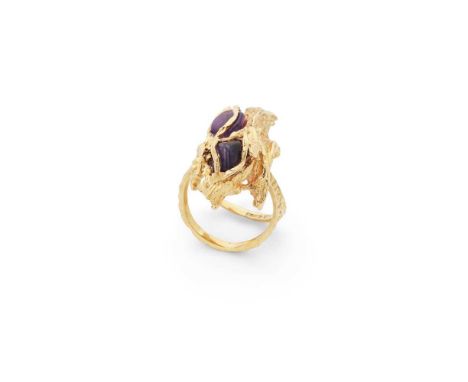 A modernist amethyst cocktail ring Of stylised textured design set with two polished amethyst pebbles, textured split shank, 