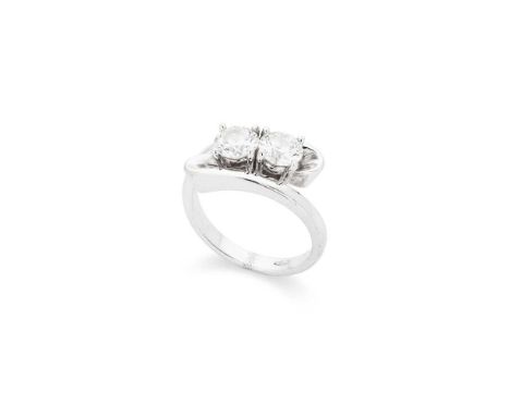 A diamond two-stone ring Claw-set with two round brilliant-cut diamonds, weighing approximately 0.70cts each, stamped 750Dime