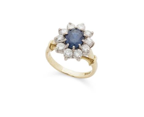 A sapphire and diamond cluster ring Claw-set with an oval-cut sapphire in a border of ten round brilliant-cut diamonds, model