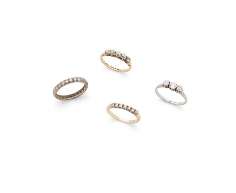 A collection of four diamond rings Including a three-stone old round-cut diamond ring, unmarked; an eight-cut diamond half-et