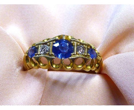 An 18ct gold Engagement ring, two diamonds flanked by central sapphire and two smaller sapphires, Birmingham, date letter 'R'