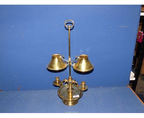 A brass double candlestick with small conical brass shades.