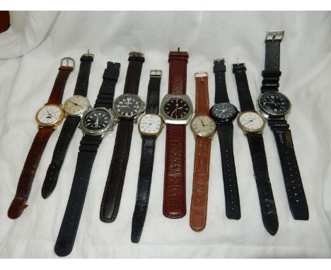 A lidded wooden box containing ten gentlemen's wristwatches including RJW quartz with day/date/month dials and moon-phase,a S