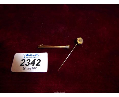 A 15ct gold stick pin with diamond chip, 1.03 gm., together with a rolled gold bar brooch.