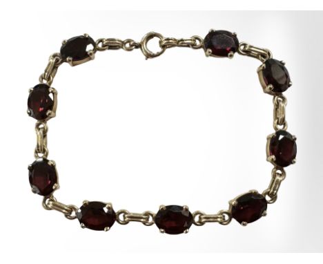A 14ct gold garnet bracelet, length 18cm.  CONDITION REPORT: 12.2g