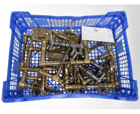 A crate of vintage brass door handles.