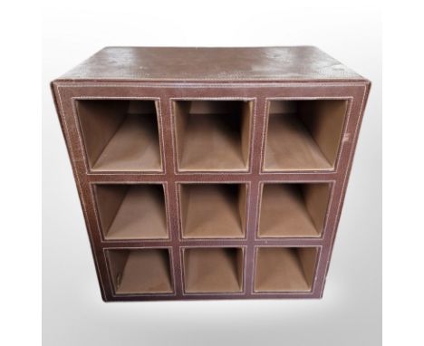 A leather cube shelf, height 40cm.