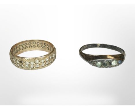 A 9ct gold dress eternity ring (stones deficient) and a silver ring.  CONDITION REPORT: 9ct ring 3.1g. 