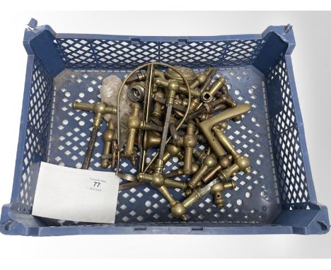 A crate of vintage brass door handles.