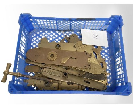 A crate of vintage brass door plates.