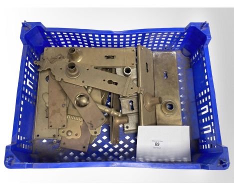 A crate of vintage brass door plates.