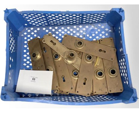A crate of vintage brass door plates.
