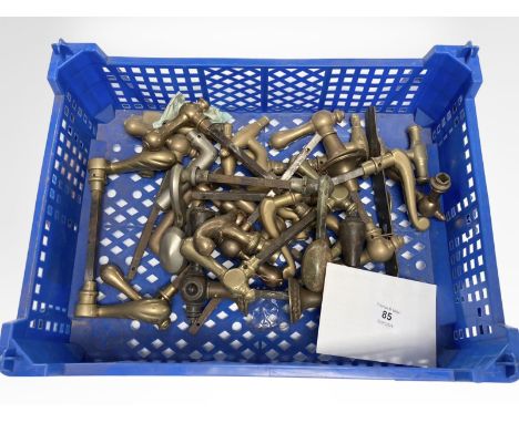 A crate of vintage brass door handles.