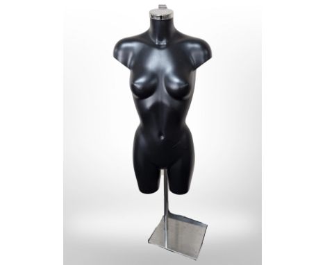 A female mannequin on chrome stand 