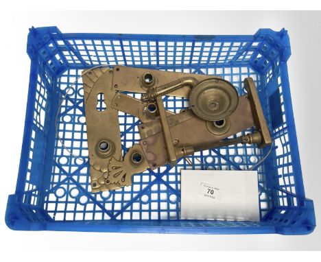 A crate of vintage brass door plates and two handles.