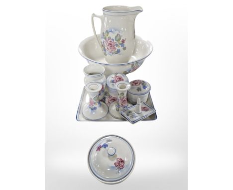 An English pottery transfer-printed wash jug and basin and several matching dressing table pieces.