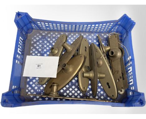 A crate of vintage brass door plates.