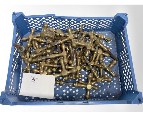 A crate of vintage brass door handles.