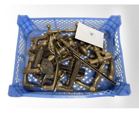 A crate of vintage brass door handles.