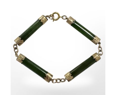 A gold-mounted jadeite bracelet, length 19.5cm