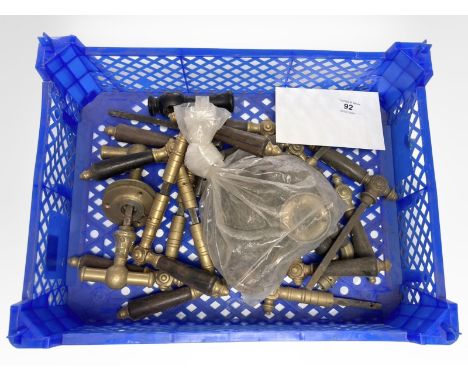 A crate of vintage brass and other door handles.