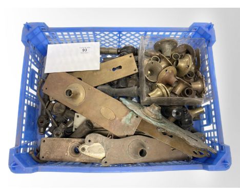 A crate of vintage brass door plates, brass fittings, etc.