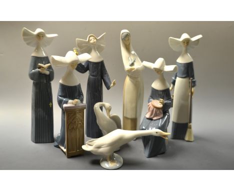 A Lladro pottery figure of a Nun seated, others standing;  another Goose;  a Nao figure cradling a rabbit etc printed and imp