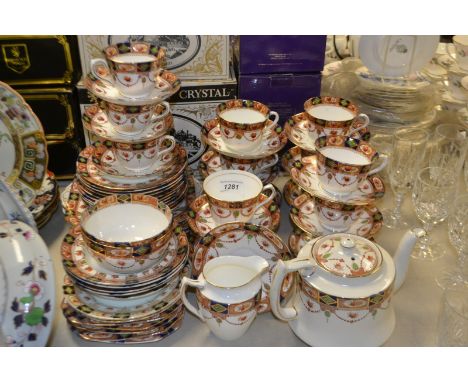 A Staffordshire tea service decorated with summer flowers with a garland edged border comprising, teapot, cups and saucers, t