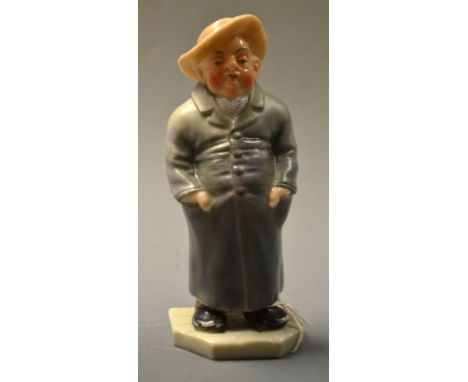 A  Royal Worcester figure,  from the 'Down and Out' series, standing, with hands in his pockets, wearing a broad brimmed hat 
