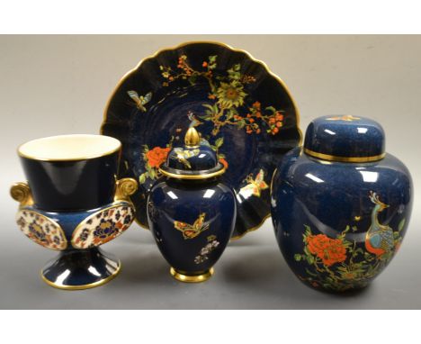 A Carltonware Chinoiserie enameled ginger jar and cover, printed and painted with peacock perched on blossoming branches, on 