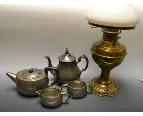 A brass and opaque glass shade oil lamp;  a Tudric Pewter hammered three piece tea service, 01538