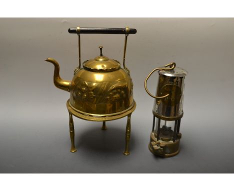 An Eccles miners lamp; an Arts and Crafts embossed brass kettle; a pierced brass trivet (3)