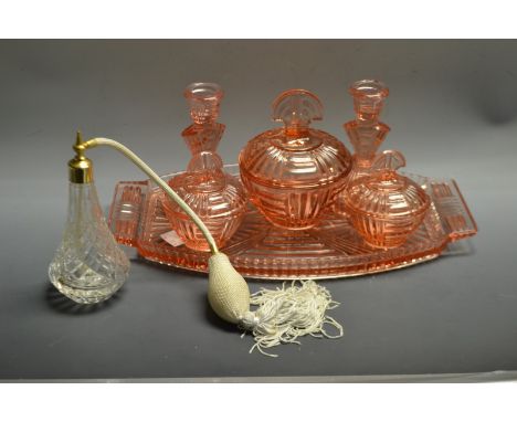 A 1950s peach glass six pieces dressing table set, inc shaped ovoid tray, pair of candlesticks, trinket pots etc ;  a clear g