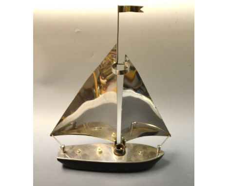 A aluminum and wooden lamp, as a sailing yacht