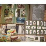 POSTCARDS, a large collection of postcards in three albums and loose; together with a cigarette card