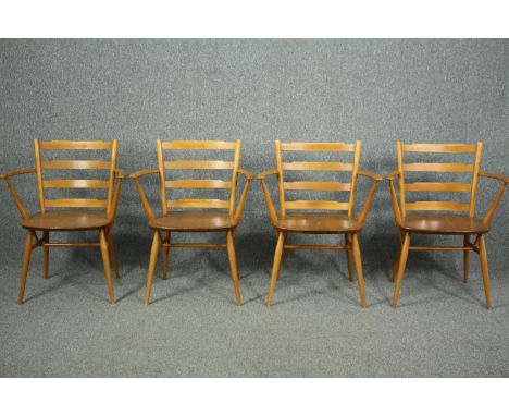 Dining chairs, a set of four with arms, Ercol model 559A in beech and elm. 