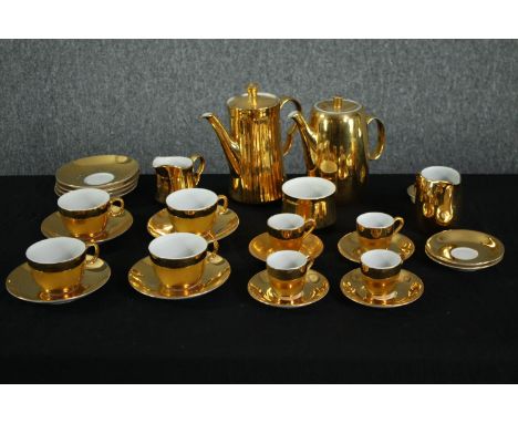 A vintage Royal Worcester gold lustre pattern tea set. Incomplete. Comprised of a teapot, coffee pot, two creamers, and six l