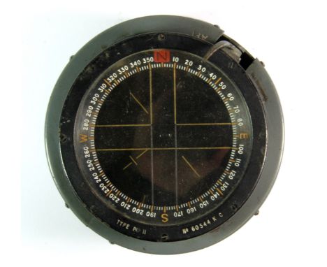 A vintage military aircraft compass.