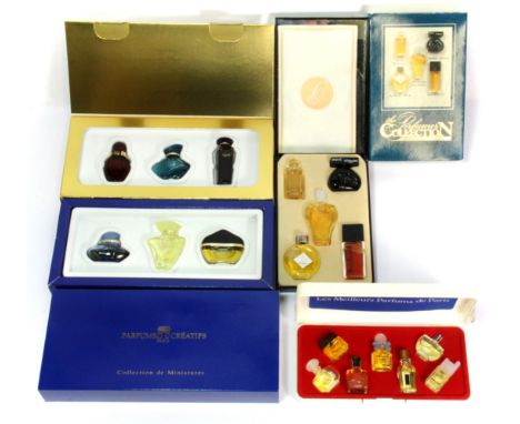 Three vintage boxes of perfume collections.