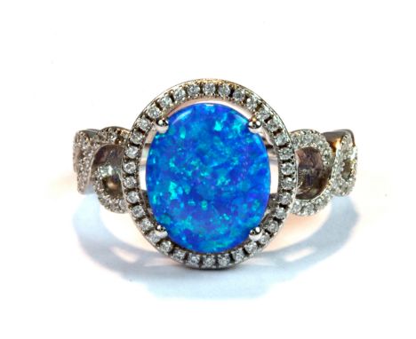 A 925 silver ring set with a blue faux opal and cubic zirconia (R.5).