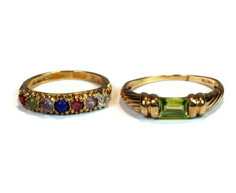 A 9ct yellow gold ring set with a baguette cut peridot (R) and a further 9ct yellow gold multi stone set half eternity ring (