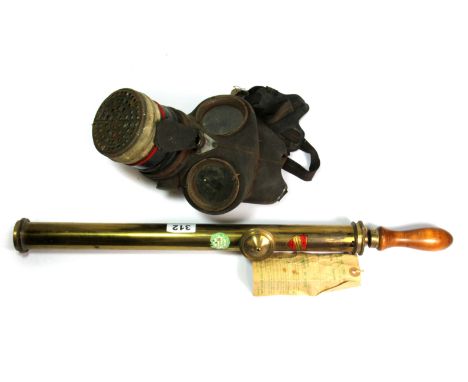 A vintage Donald Edward Ltd, garden syringe and a gas mask.