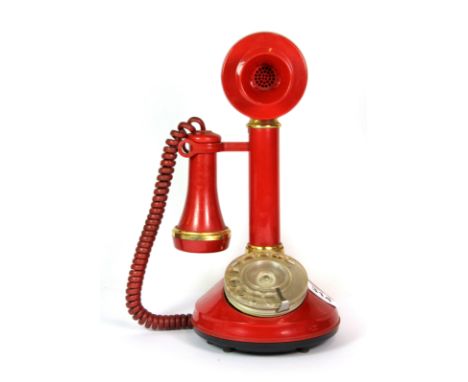 A 1970's red stick telephone.