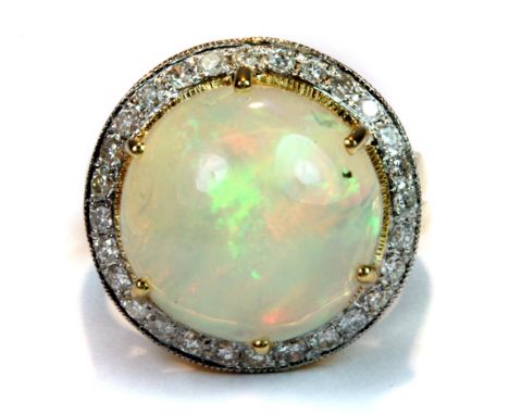 A stunning 18ct yellow gold (stamped 750) set with a large cabochon cut opal (approx. 7.2ct) surrounded by brilliant cut diam