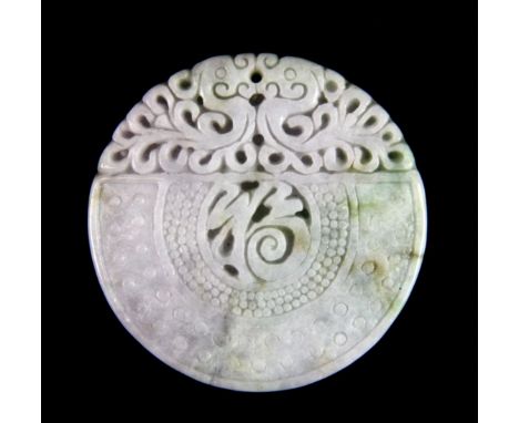 An intricately carved Chinese pale green and lavender jade disc amulet, Dia. 5.5cm.