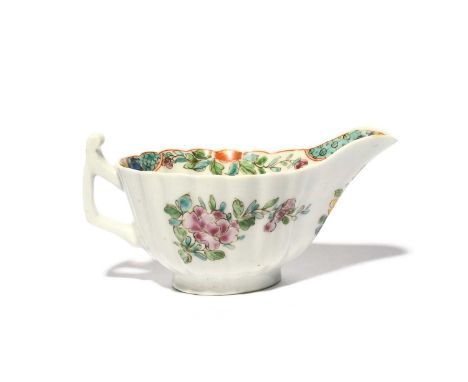 A rare and early Worcester creamboat, c.1750-53, of simple fluted form with an angular handle, the floral decoration painted 