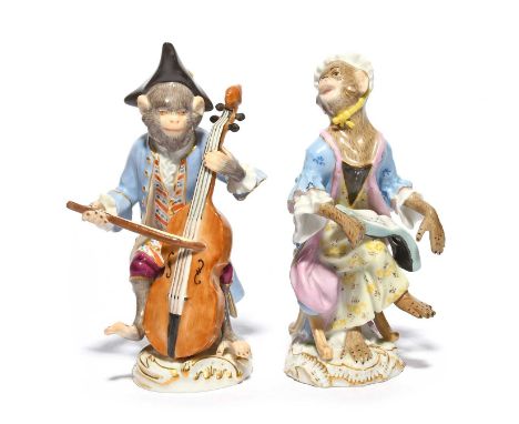 Two Meissen figures from a monkey band (affenkapelle), 19th/20th century, modelled as a seated cellist wearing a blue coat ov