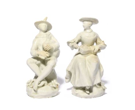 A pair of white-glazed Bow figures of Harlequin and Columbine, c.1755, each seated on a low rocky stump applied with flowers,