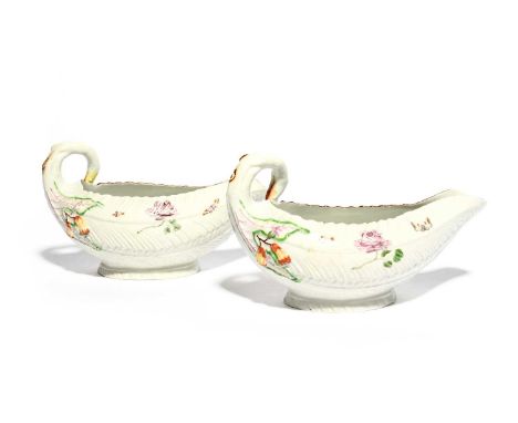 A pair of Worcester cos leaf sauceboats, c.1757, crisply moulded with overlapping leaves, painted with butterflies, other ins