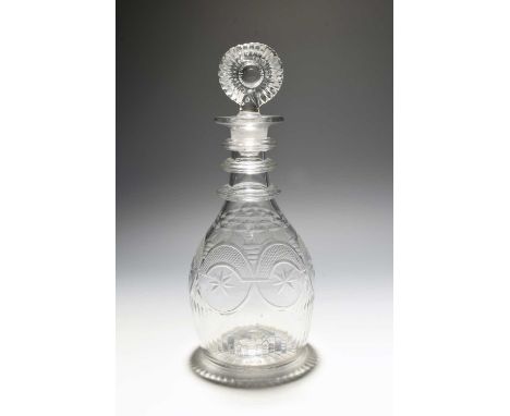 An Irish glass decanter and stopper, c.1820, Waterloo Glass Works of Cork, of Prussian shape, engraved with star motifs and h